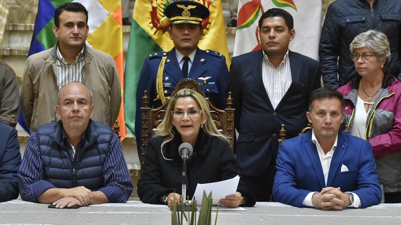 The interim president of Bolivia, Jeanine Añez (C), delivers a speech surrounded by members of her cabinet