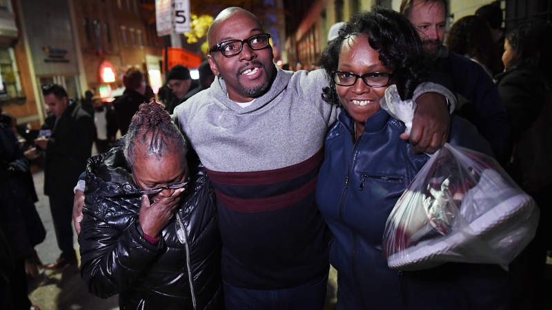 Mary Stewart (L) walks with her son Andrew and daughter Ulonda after he, along with Alfred Chestnut and Ransom Watkins, were released