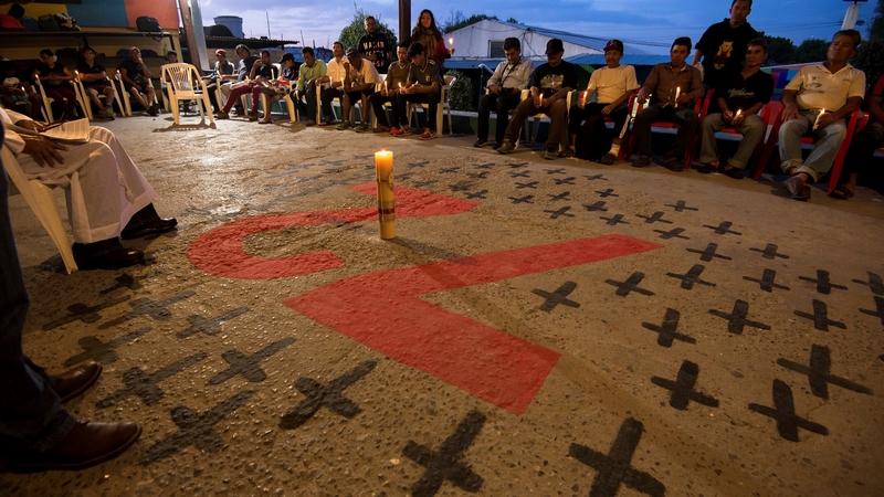 Relatives pray at a ceremony to remember 72 victims of 2011 massacre carried out by the 'Los Zetas' cartel