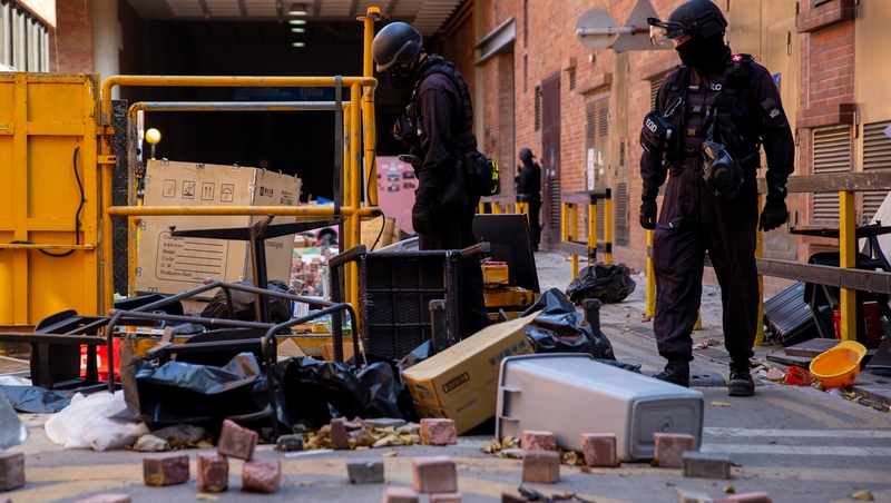 Officers from a bomb disposal unit search the campus of Hong Kong Polytechnic University