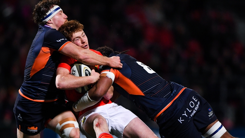 Ben Healy of Munster is tackled by Hamish Watson and Villame Mata