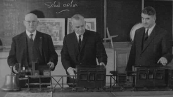 Michael Ash, Michael Caine and Bryan MacMahon with model of the Lartigue monorail, Listowel (1964)