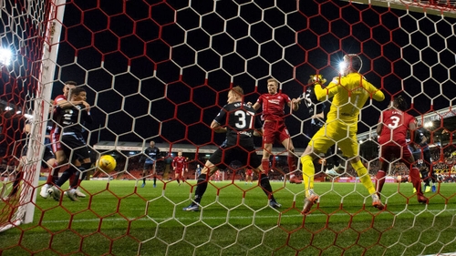 Aberdeen's Sam Cosgrove heads a chance wide during the Premiership match against Rangers at Pittodrie