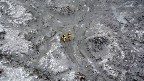 Military specialists wearing protective clothing helped recover six bodies