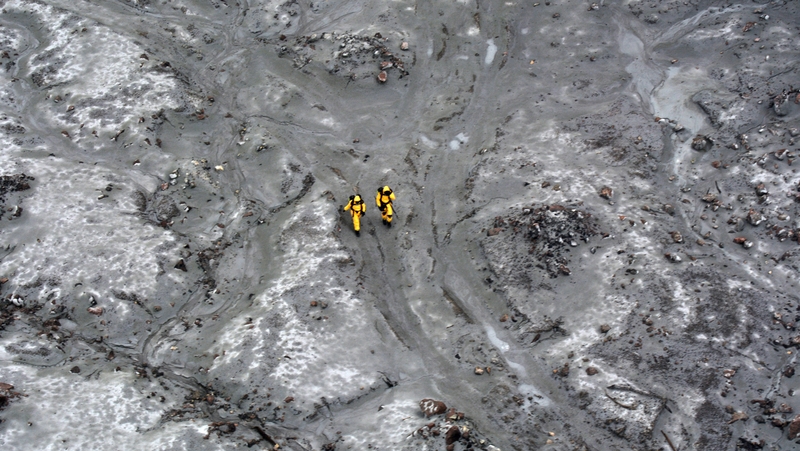 Military specialists wearing protective clothing helped recover six bodies