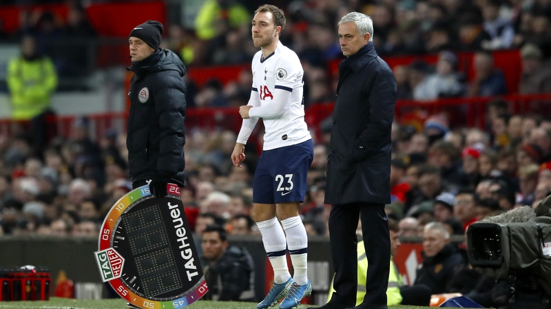 Tottenham Hotspur's Christian Eriksen (C) on the touchline with manager Jose Mourinho (R)