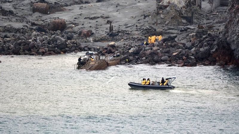 Members of the New Zealand Defence Forces search the island in the recovery operation