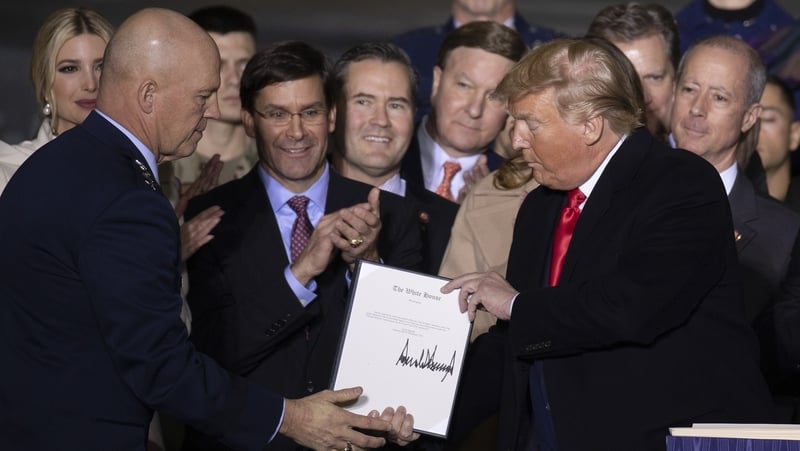 Operations Chief John Raymond and Donald Trump at the signing ceremony for The National Defense Authorization Act for Fiscal Year 2020