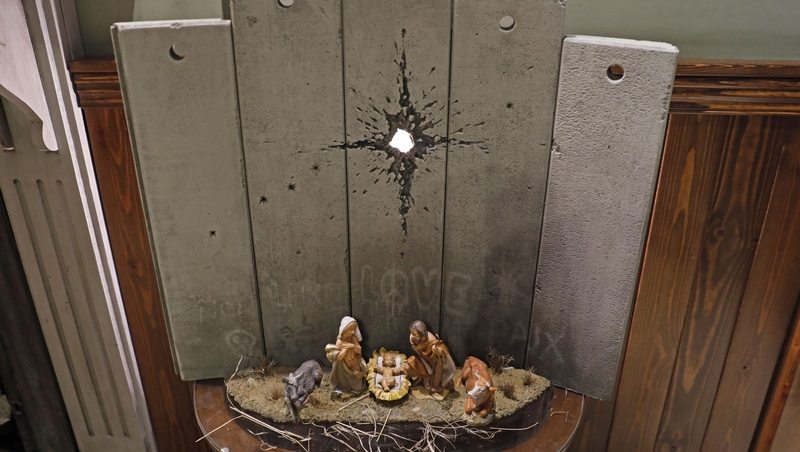 The work is installed at Banksy's Walled-Off Hotel, where all rooms overlook a concrete section of the barrier built by Israel