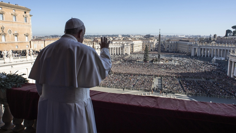 Pope Francis waves from the balcony of St Peter's basilica during the traditional "Urbi et Orbi" Christmas message