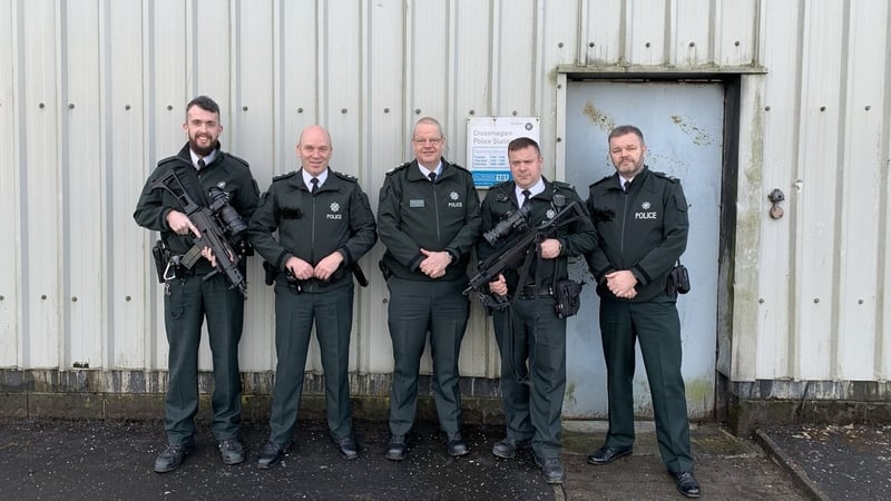 A picture posted on his Twitter account shows PSNI Chief Constable Simon Byrne posing with officers armed with machine guns