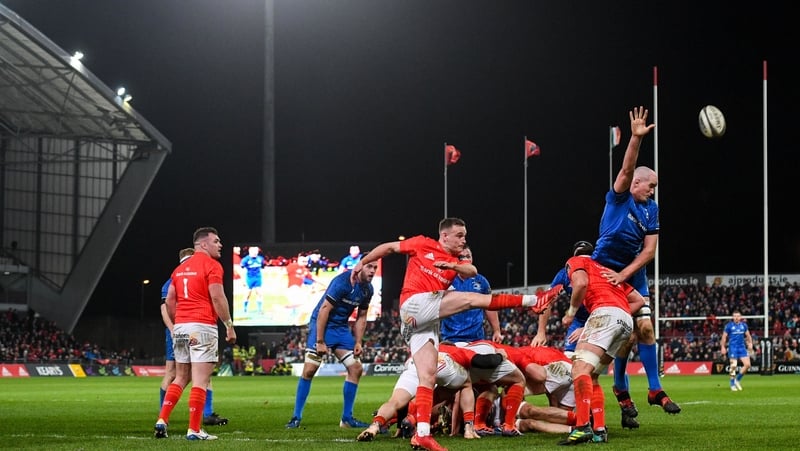 Nick McCarthy of Munster clears under pressure from Devin Toner