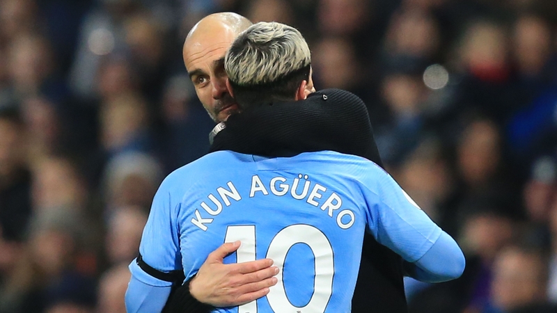 Manchester City manager Pep Guardiola (L) hugs Sergio Aguero
