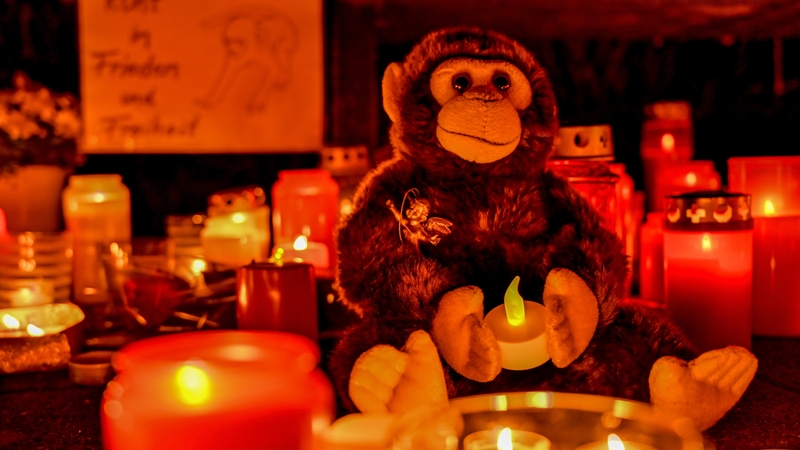 Candles and soft toys are placed at the entrance outside of the zoo in Krefeld last night