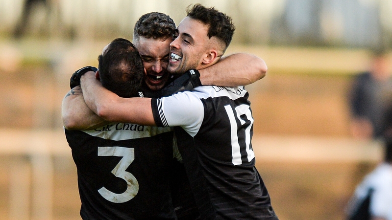 Aidan Branagan, Felim McGreevy, and Ryan Johnston of Kilcoo celebrate after the win over Naomh Conaill