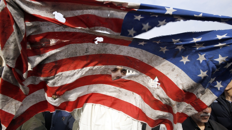 An American flag is defaced during an anti-US demonstration in Tehran today