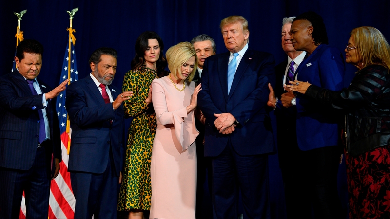 Pastors gathered around Donald Trump for the opening prayer