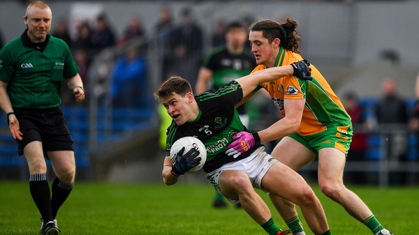 Kevin O'Donovan of Nemo Rangers is tackled by Kieran Molloy of Corofin