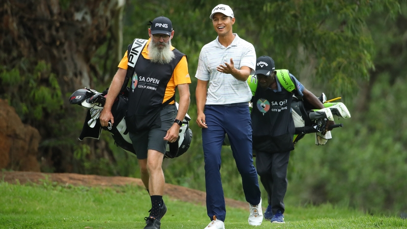 Johannes Veerman chats with his caddie on the final hole of his first round