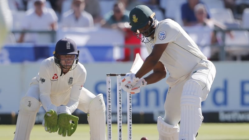 South Africa's Vernon Philander (R) plays a shot as England's Jos Buttler (L) looks on during the fifth day of the second Test