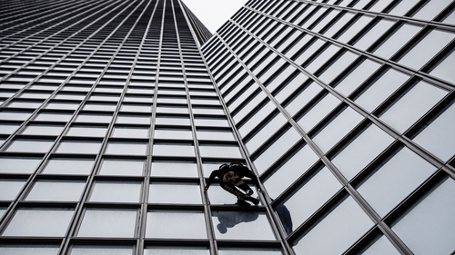 Alain Robert scaled the 187m tower in support of the pension strike in France