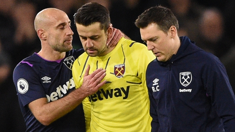 Lukasz Fabianski (centre) leaves the pitch injured against Sheffield United
