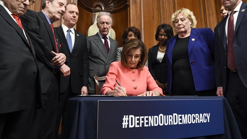 Nancy Pelosi signs the resolution to transmit two articles of impeachment against Donald Trump