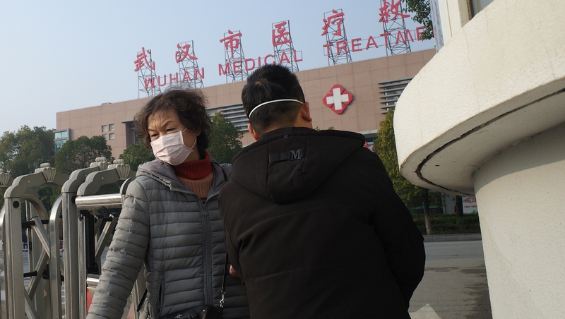 People in Wuhan wear face masks as health authorities deal with virus outbreak