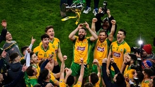 Corofin players celebrate by hoisting the Andy Merrigan Cup