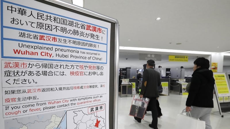 A sign urges people with symptoms to contact health authorities