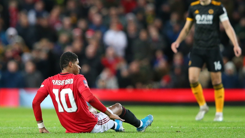 Manchester United's Marcus Rashford lies on the pitch in pain after picking up a back injury