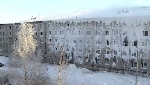While the building appears abandoned, there are families living there