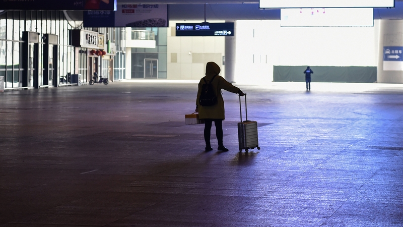 A passenger arrives at the nearly-deserted Wuhan train station