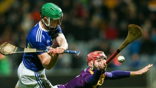 Ross King of Laois in action against Paudie Foley of Wexford