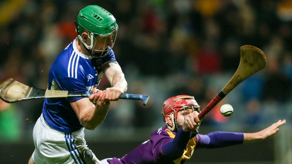 Ross King of Laois in action against Paudie Foley of Wexford