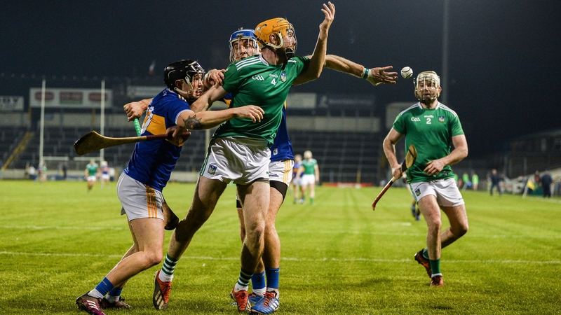 Richie English of Limerick gets a handpass away to team-mate Tom Condon