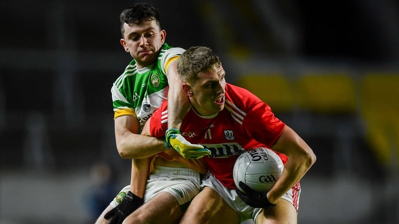 Sean White of Cork in action against Offaly's Ruairi McNamee