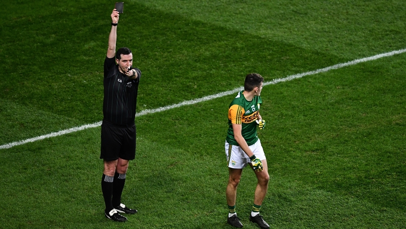 Referee Seán Hurson shows a black card to Graham O'Sullivan of Kerry