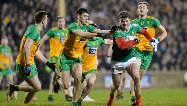Jordan Flynn of Mayo in action against Eoghan Ban Gallagher and Michael Langan of Donegal