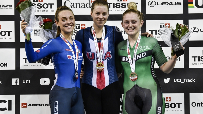 Emily Kay (r) comes home with a brobze