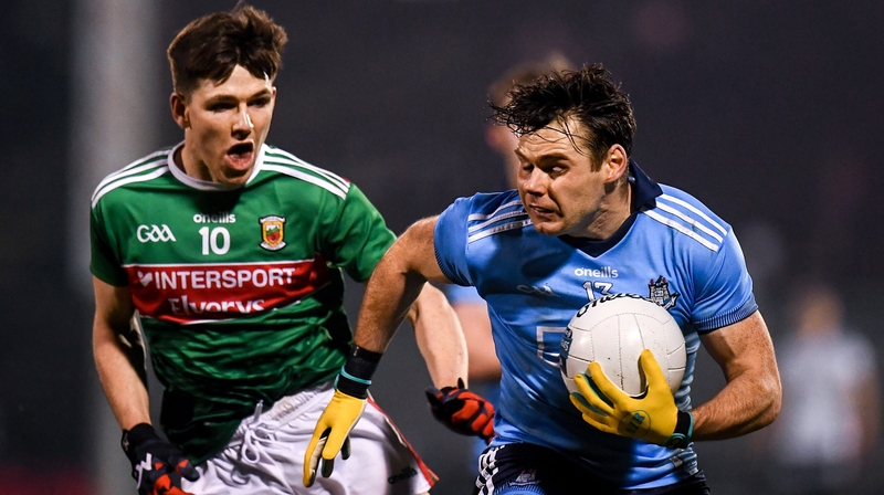 Kevin McManamon in action against Fergal Boland