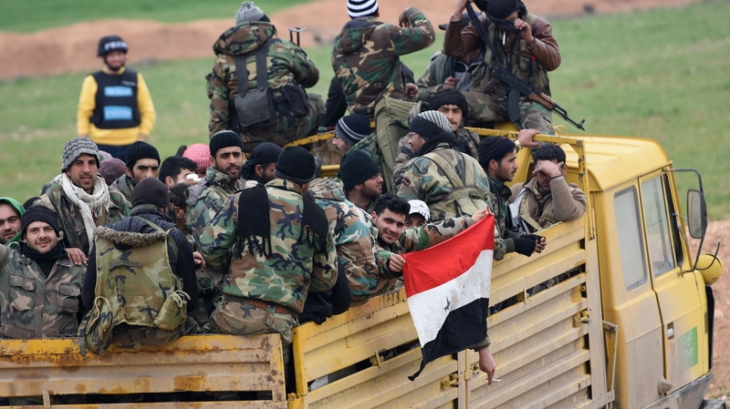 Syrian Army soldiers advance towards Saraqeb in Idlib province