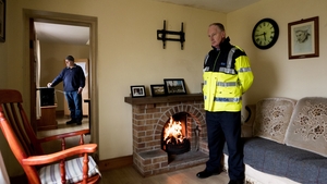 Garda McBride stands guard as Eddie casts his vote