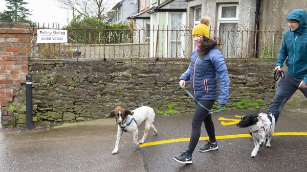 People walk by a polling station at Gardiner's Hill during general elections in Cork city