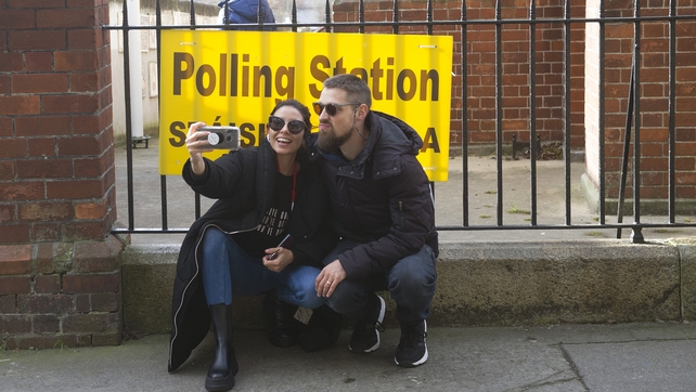 No selfies allowed in the polling stations, but this couple still got one in outside a Dublin vote venue
