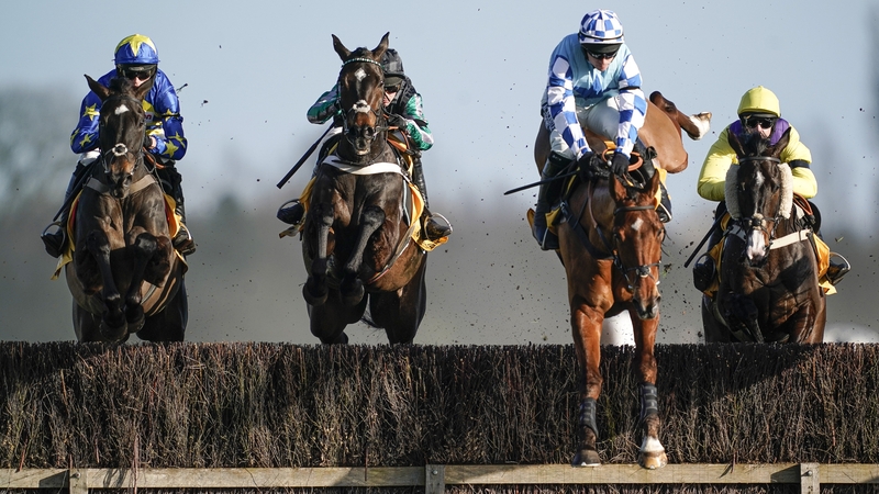 Altior (2L) and Nico de Boinville clear the water jump before going on to win at Newbury on Saturday.