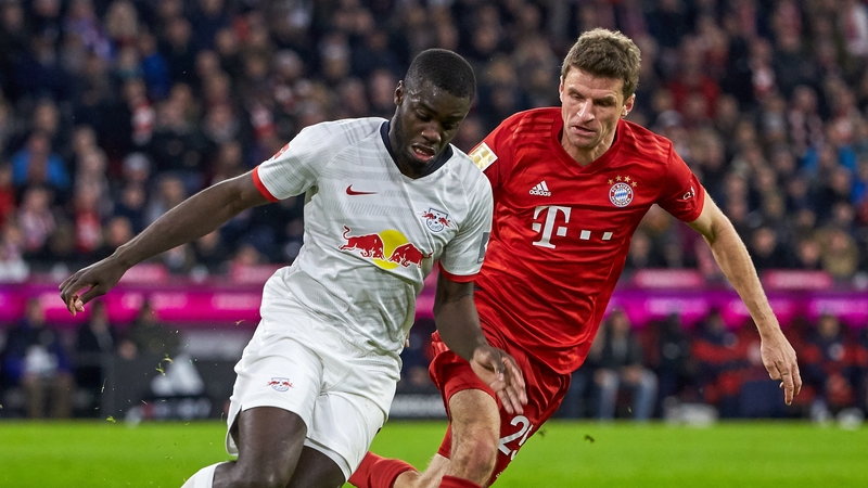 Dayot Upamecano of RB Leipzig and Thomas Muellerof FC Bayern Munich