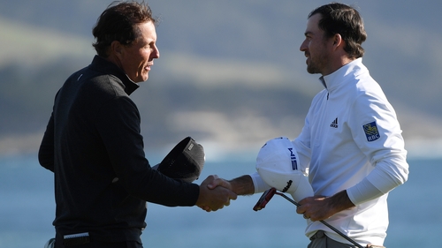 Nick Taylor (R) shakes hands with Phil Mickelson after winning the AT&T Pebble Beach ProAm.