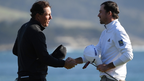 Nick Taylor (R) shakes hands with Phil Mickelson after winning the AT&T Pebble Beach ProAm.