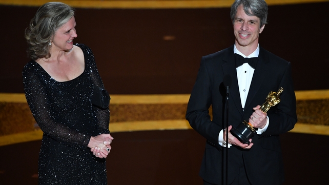 US director Marshall Curry (R) and Elizabeth Martin accept the award for Best Live Action Short Film for The Neighbors' Window